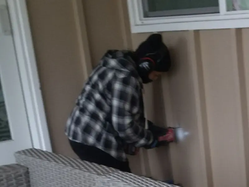Professional electrician installing an exterior outlet in Empire